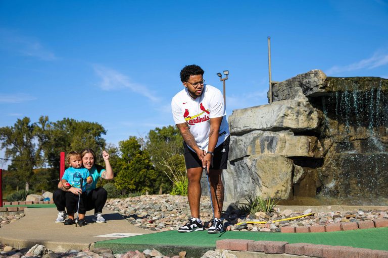 family playing mini golf at topcitygolf in north topeka kansas