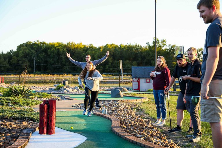 people playing mini golf at event at topcitygolf